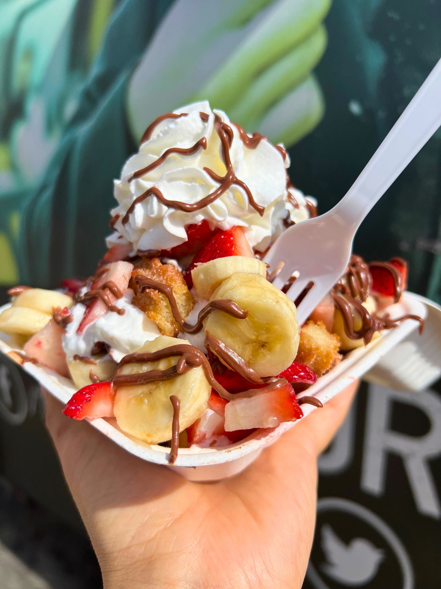#5 Churro Bites topped with fresh Strawberries, Banana, Nutella & Whipped Cream